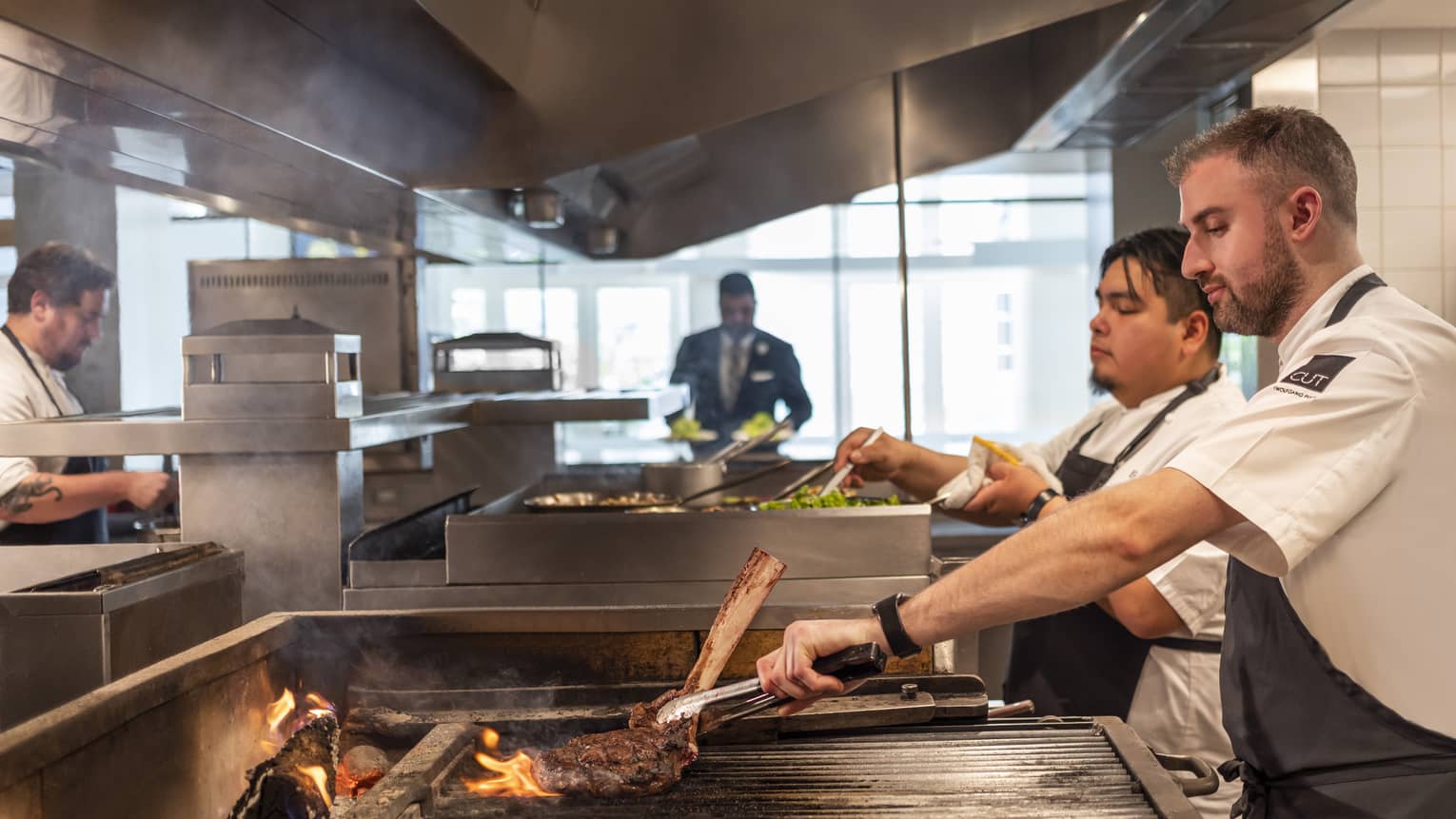 Chefs cooking food in a kitchen.