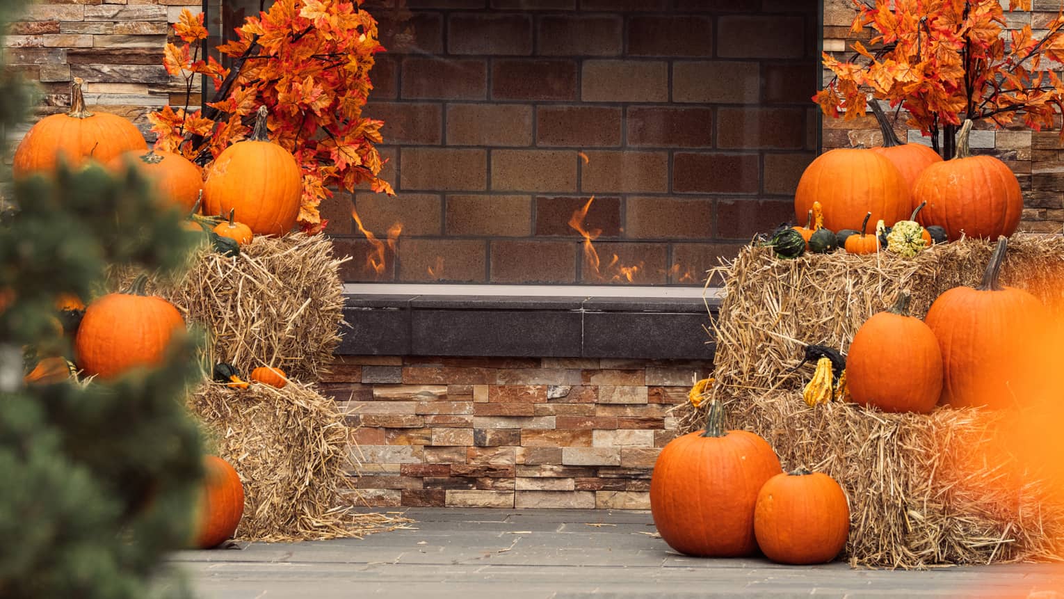 Pumpkins stacked on top of hay bales