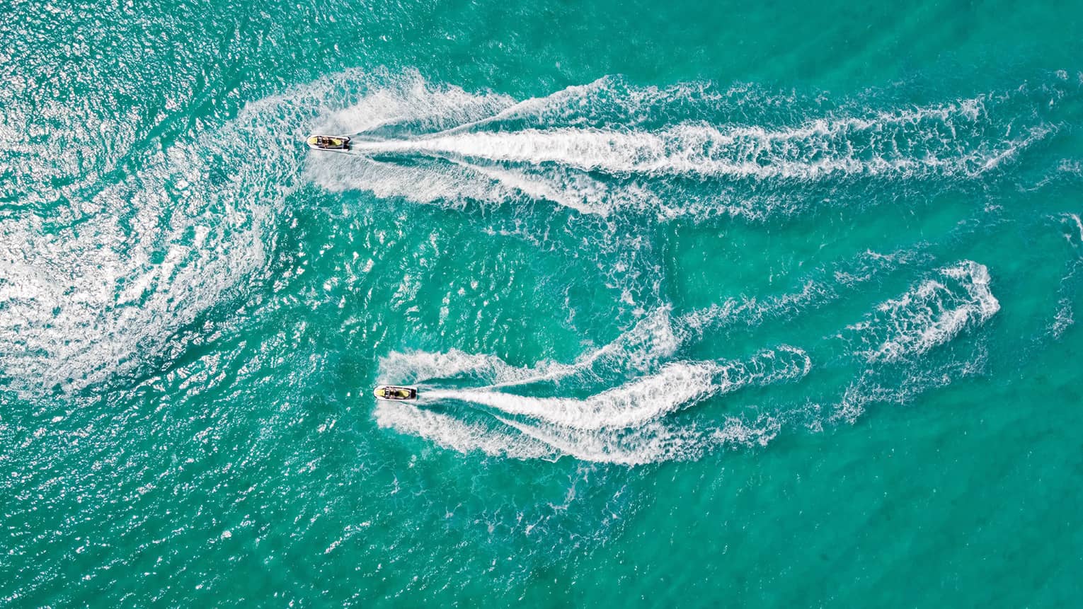 Aerial view of two people on jet skis