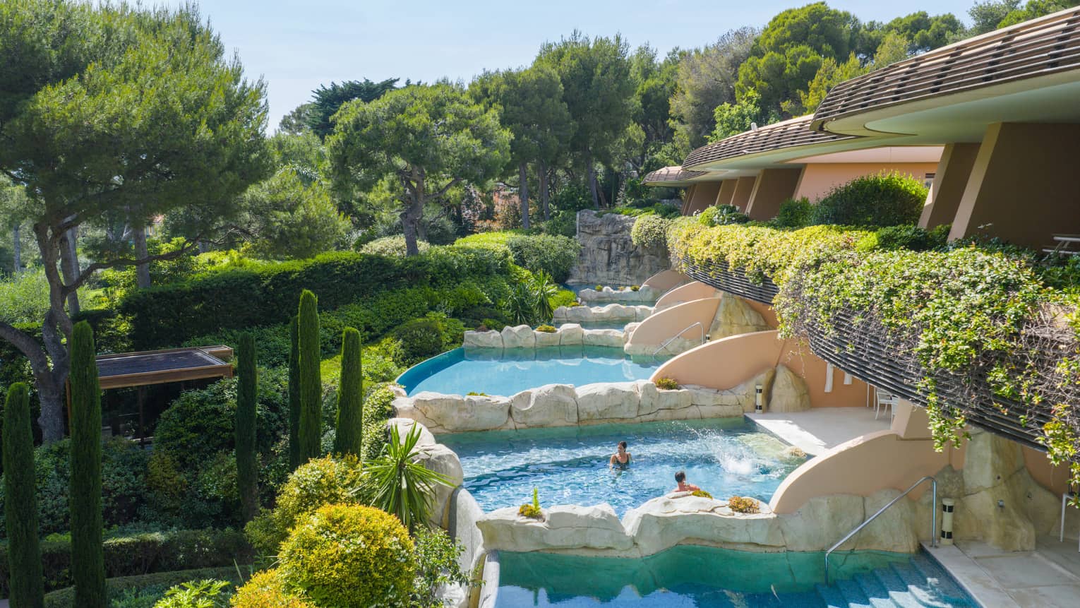 Luxury hotel rooms with private pools separated by rock walls