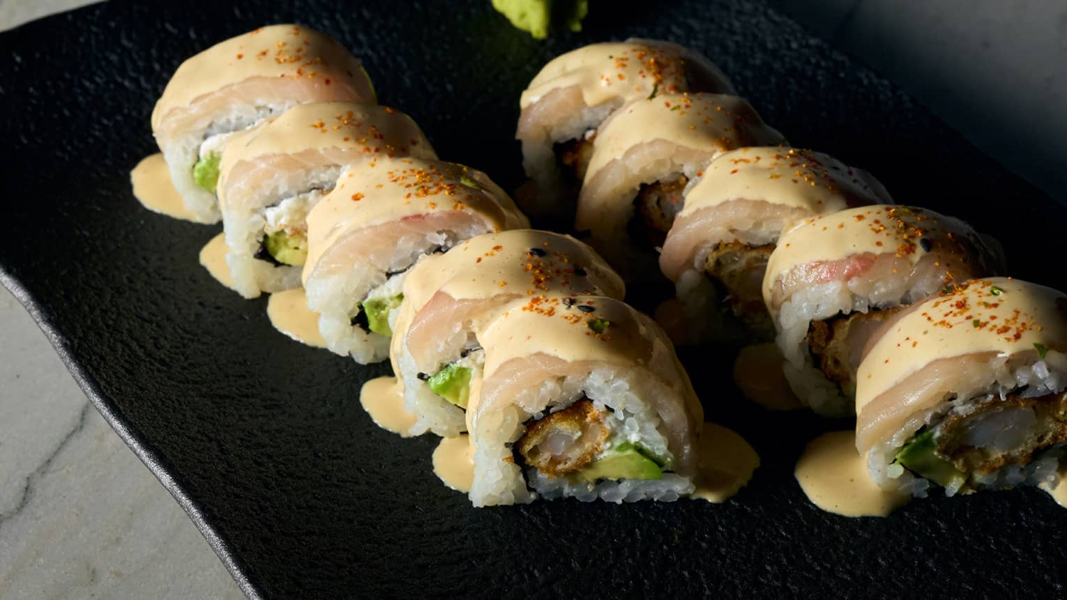 Maki rolls with rice lined on a plate
