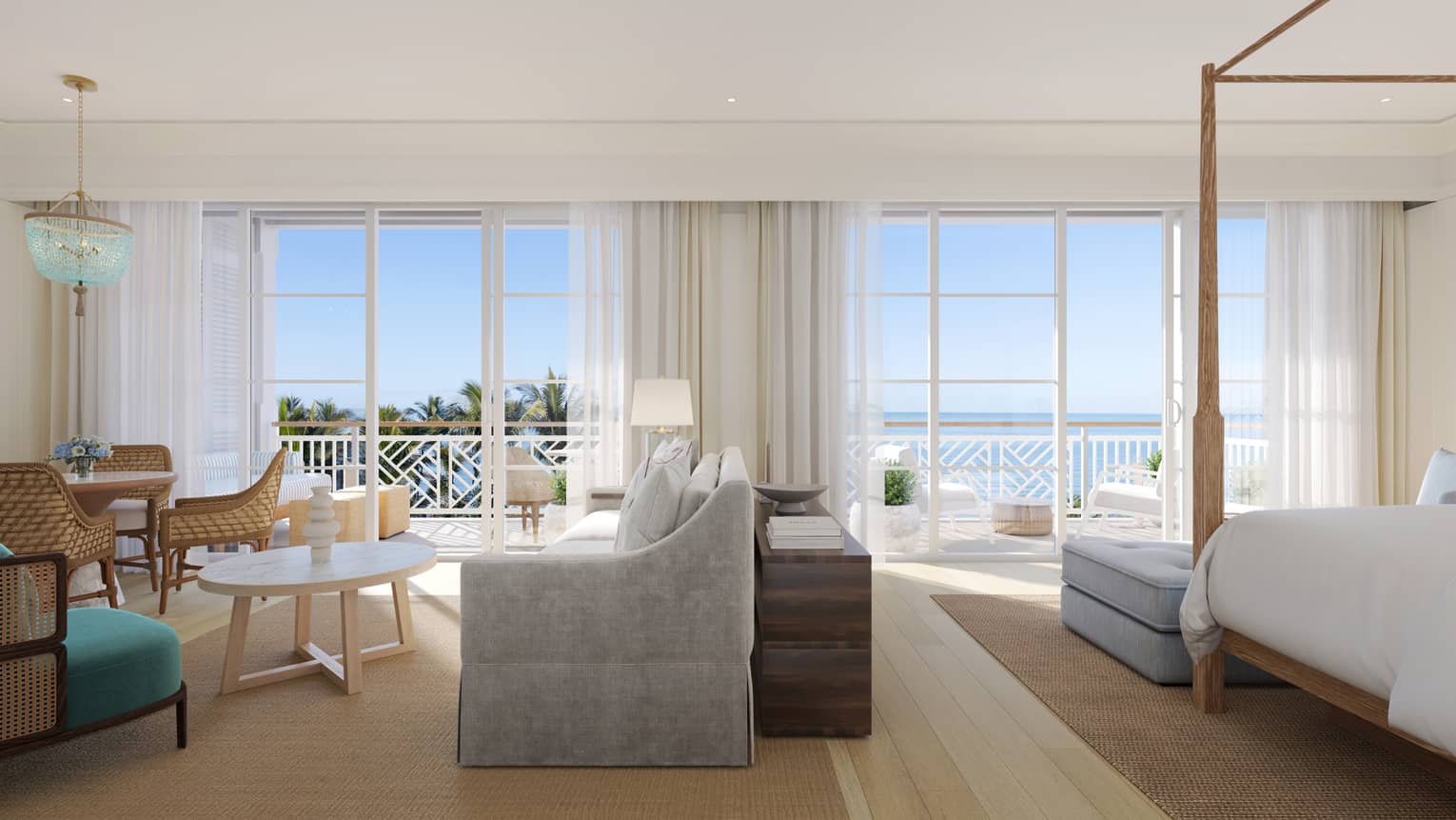 Large resort suite with four-post king bed, sitting area with sofa, dining table, and ocean-view balcony