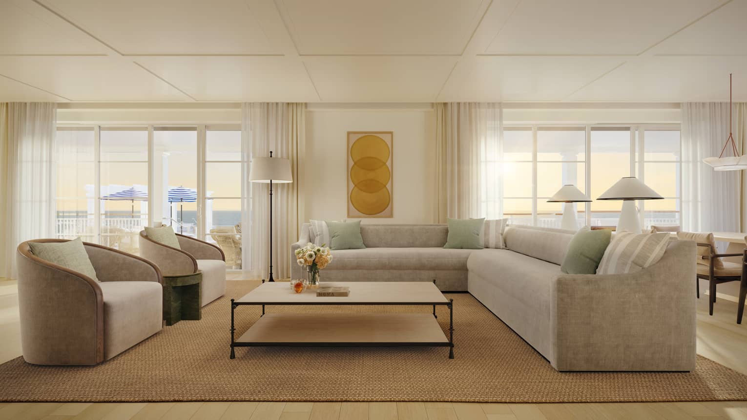 Sleek living room of a luxury suite at a resort, featuring light grey sectional sofa, large square coffee table and two chairs