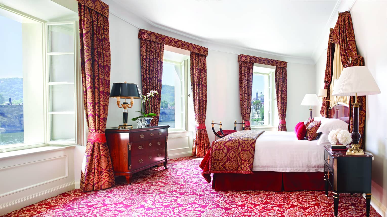 Presidential Suite with bright windows along curved wall, Baroque-inspired red-and-gold carpet, curtains