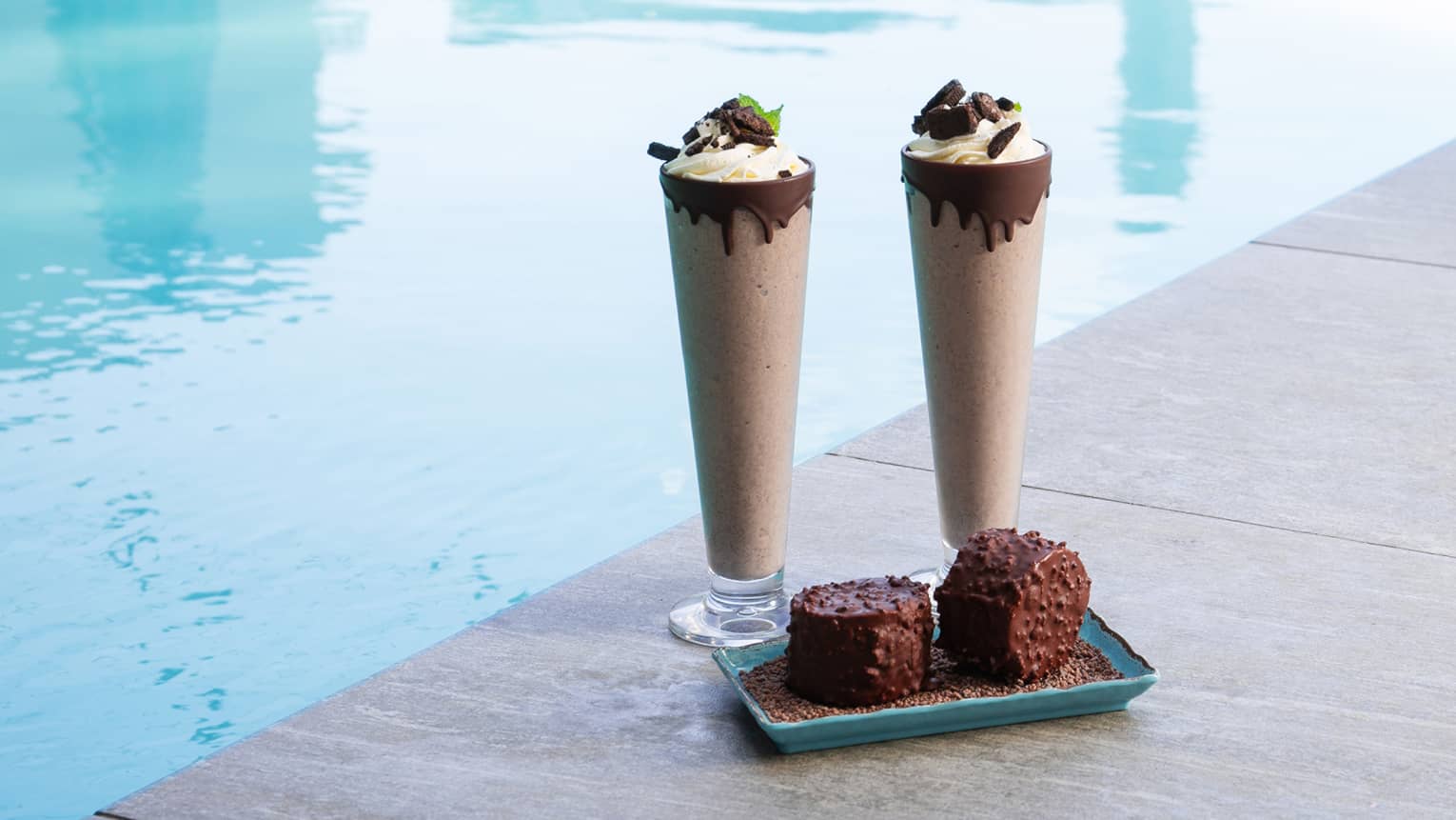 Chocolate desserts by a pool.