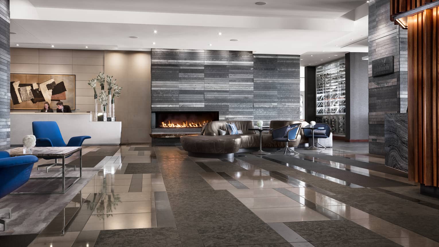 Stone tiles, marble floor, leather sofas in modern hotel lobby