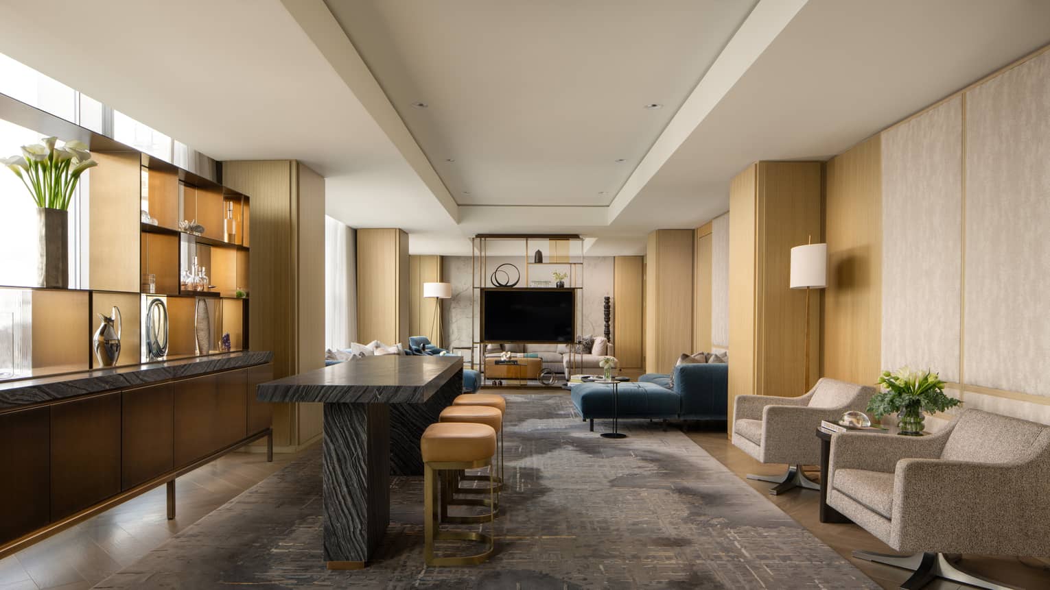 Luxury suite with a black table with stools, stylish display shelf, TV, armchairs and blue sofa