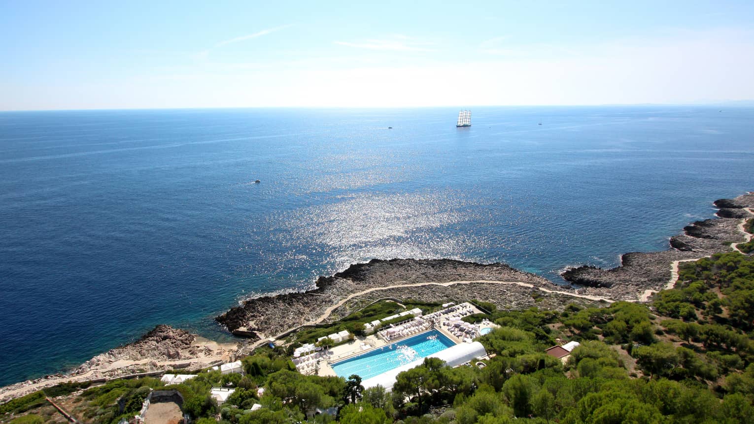 Aerial view of Four Seasons Cap Ferrat resort on lush mountain by sea