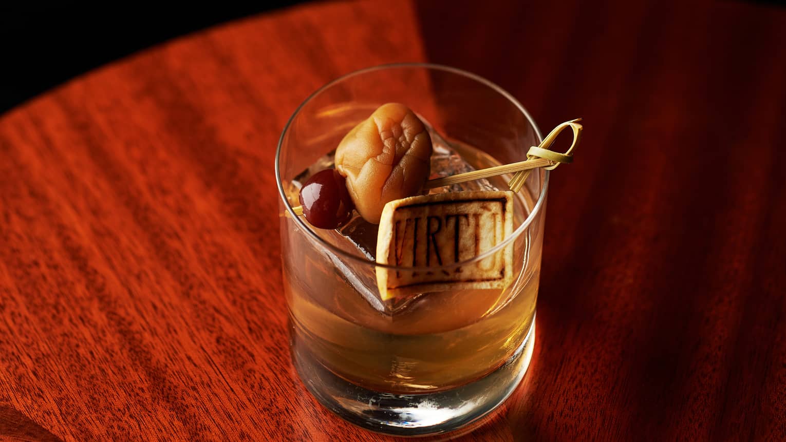 A cocktail with ume (sour plum) as a garnish.