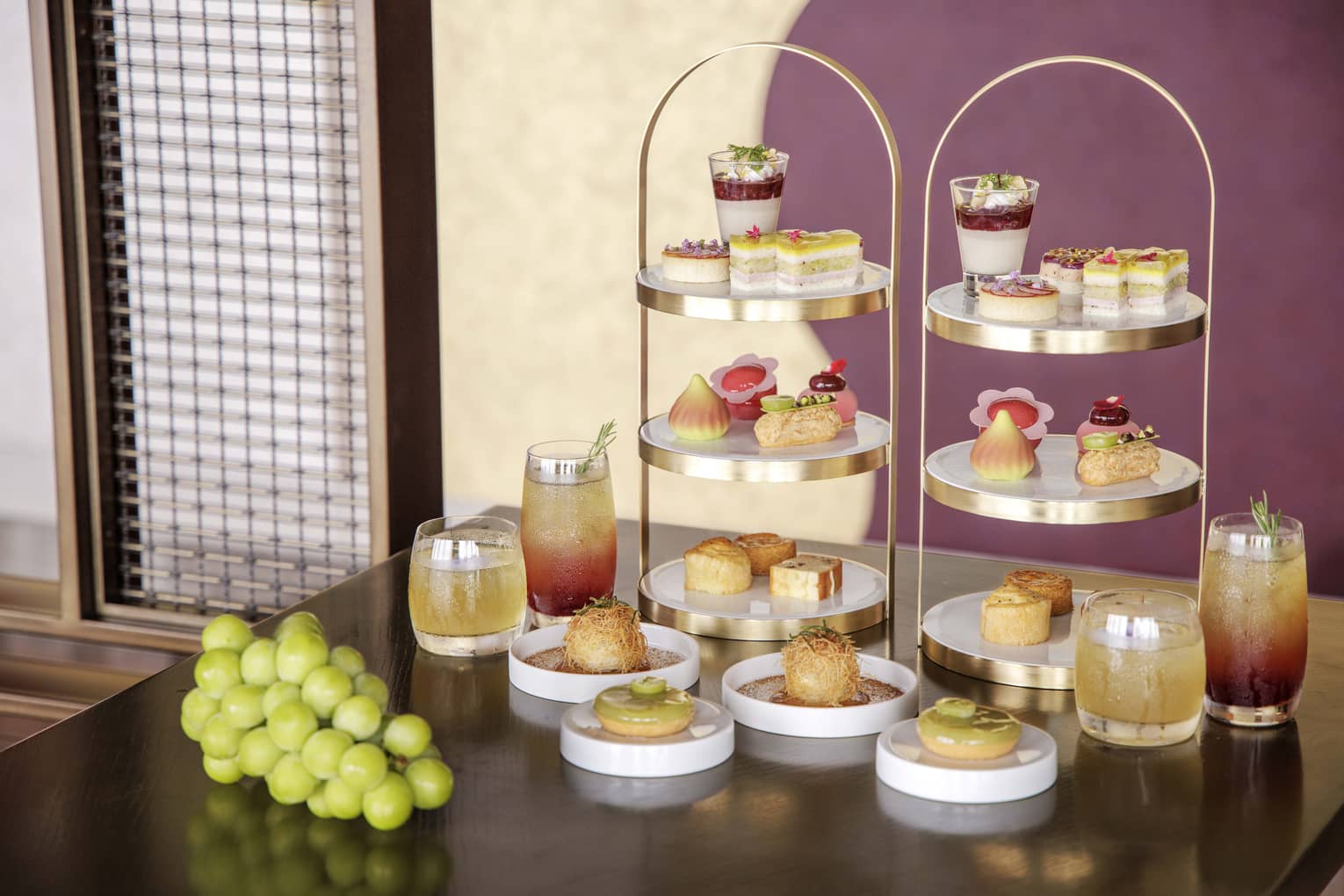 Afternoon tea spread on a table, featuring muscat grapes
