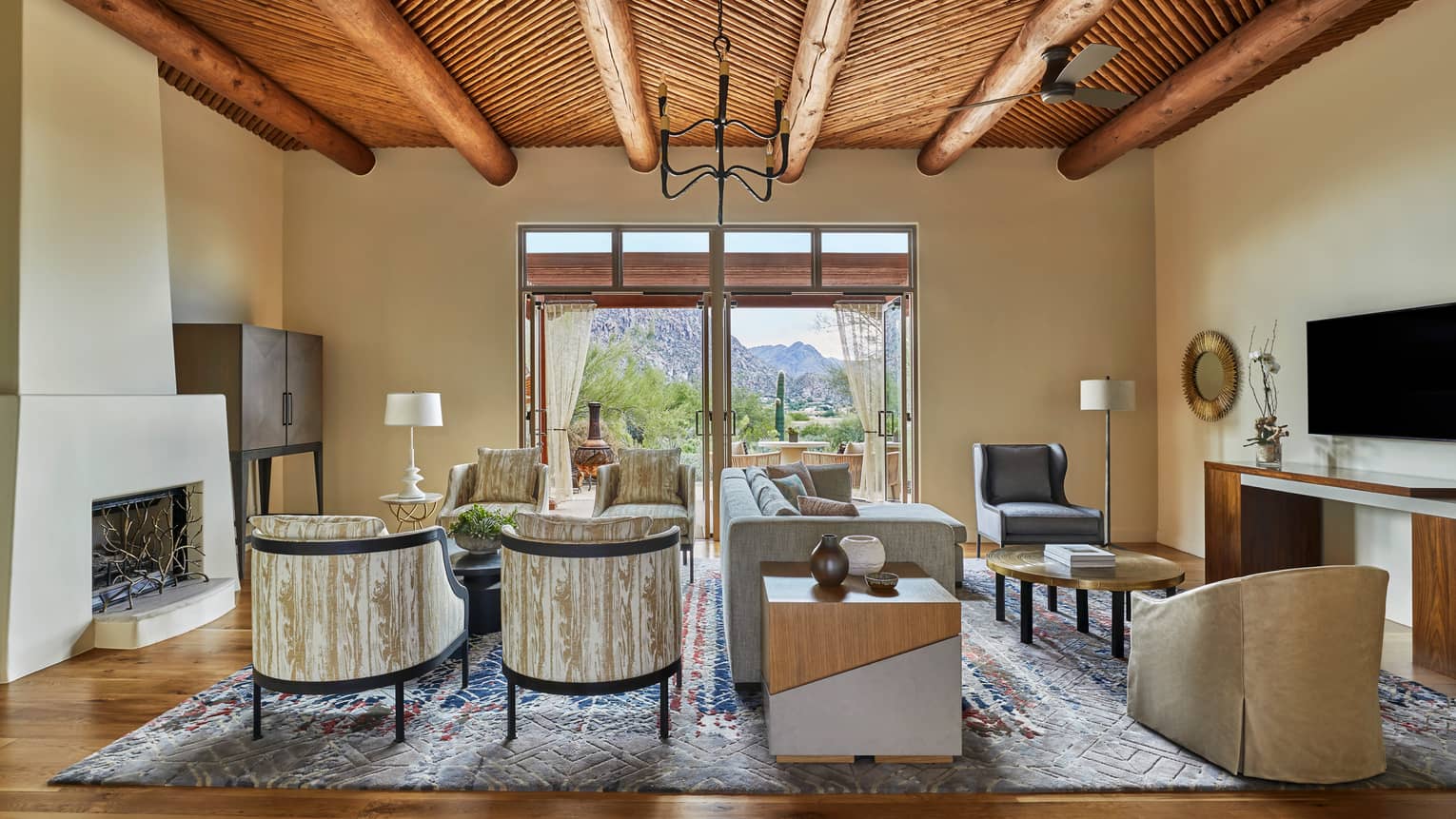 Jerome Suite modern clay fireplace and seating area with sofa, wood-grain patterned armchairs 