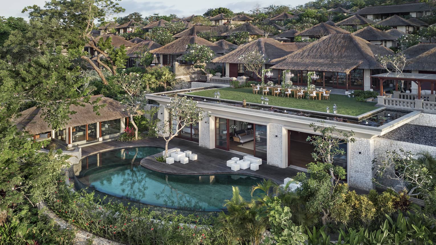 Aerial view of Imperial villa and pool surrounded by trees, event on green roof