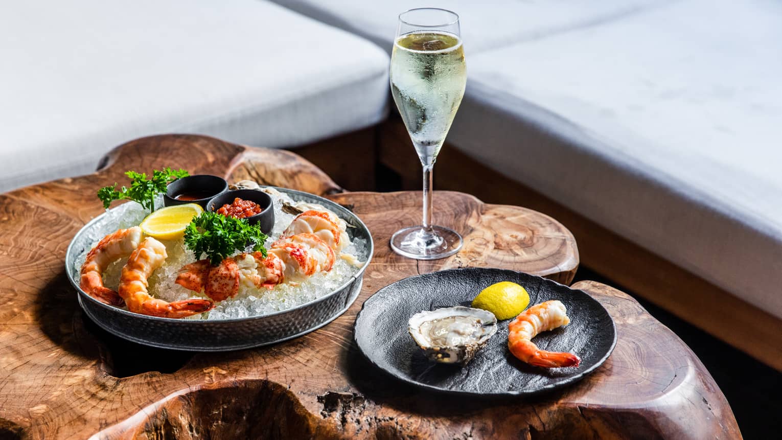An assortment of seafood and a glass of wine.
