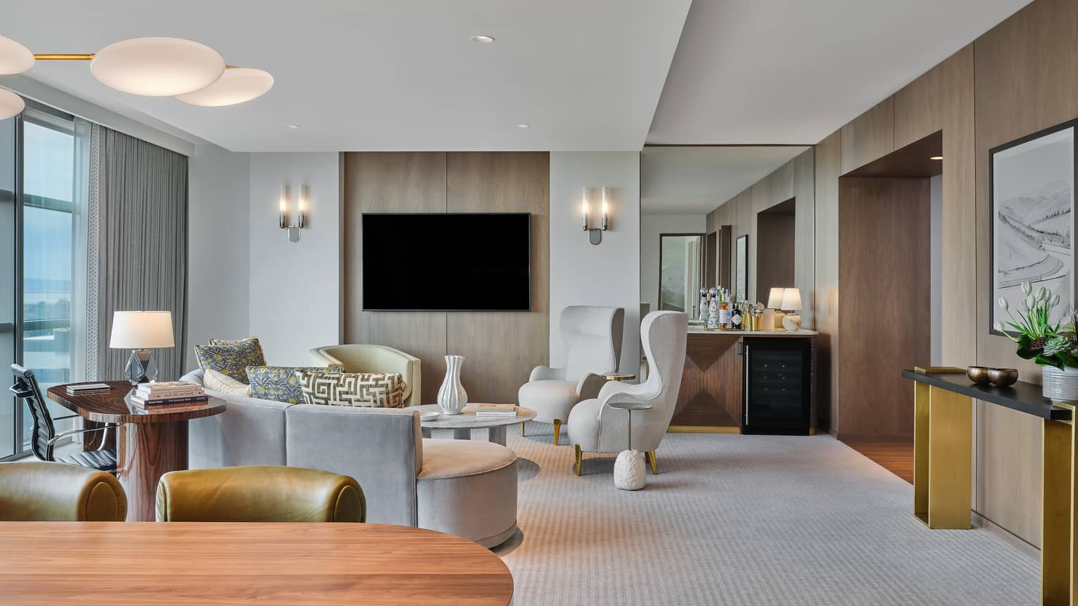 Sleek living room and dining room of hotel suite