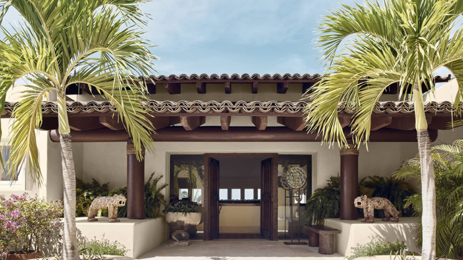 Entrance to private villa with palm trees
