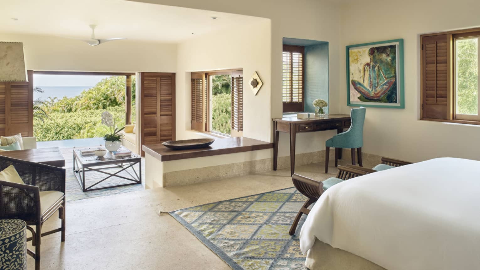 Bedroom with king bed, desk, sitting area and walk-out terrace