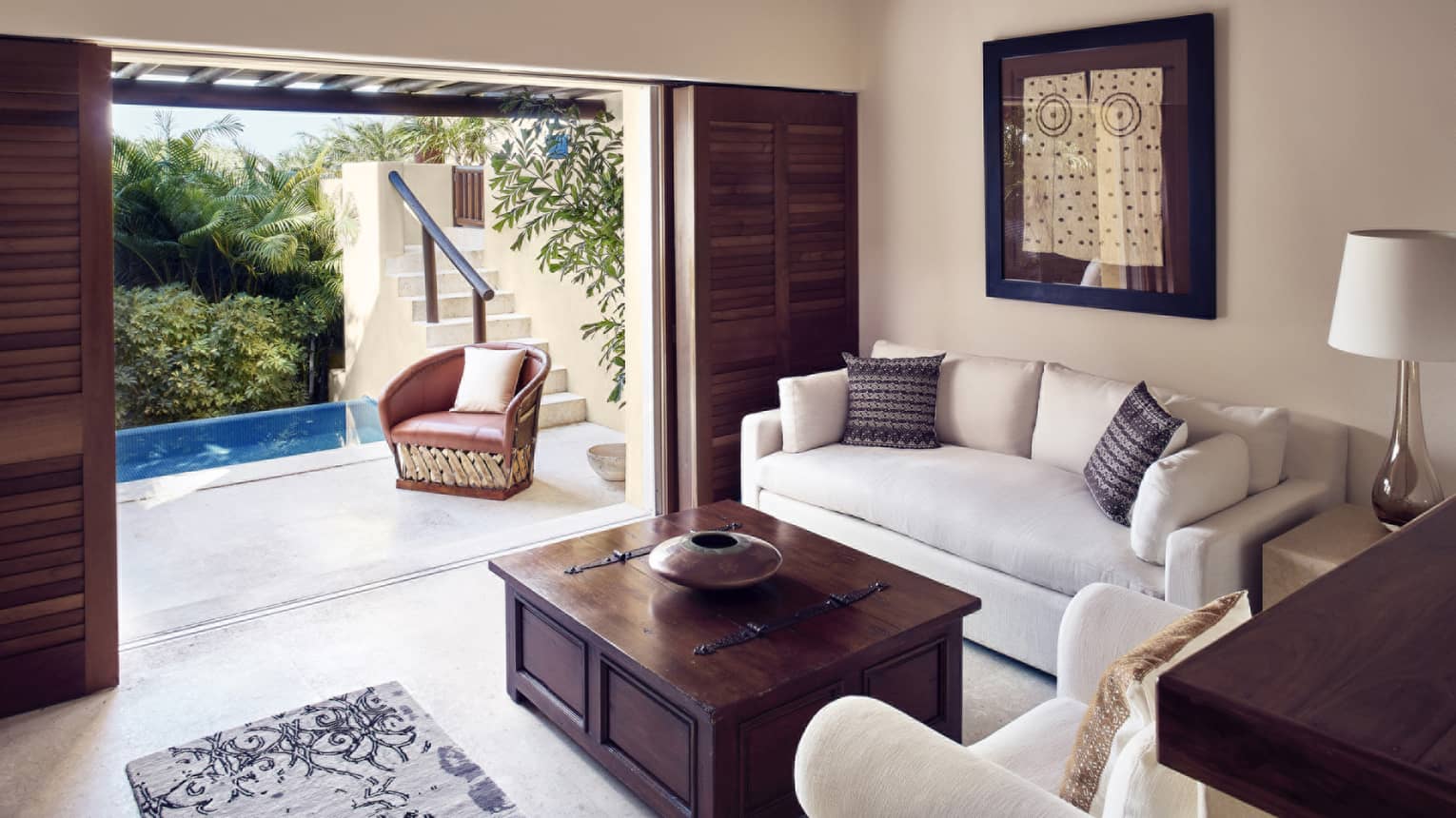 Living room with sofa, arm chair and walk-out terrace