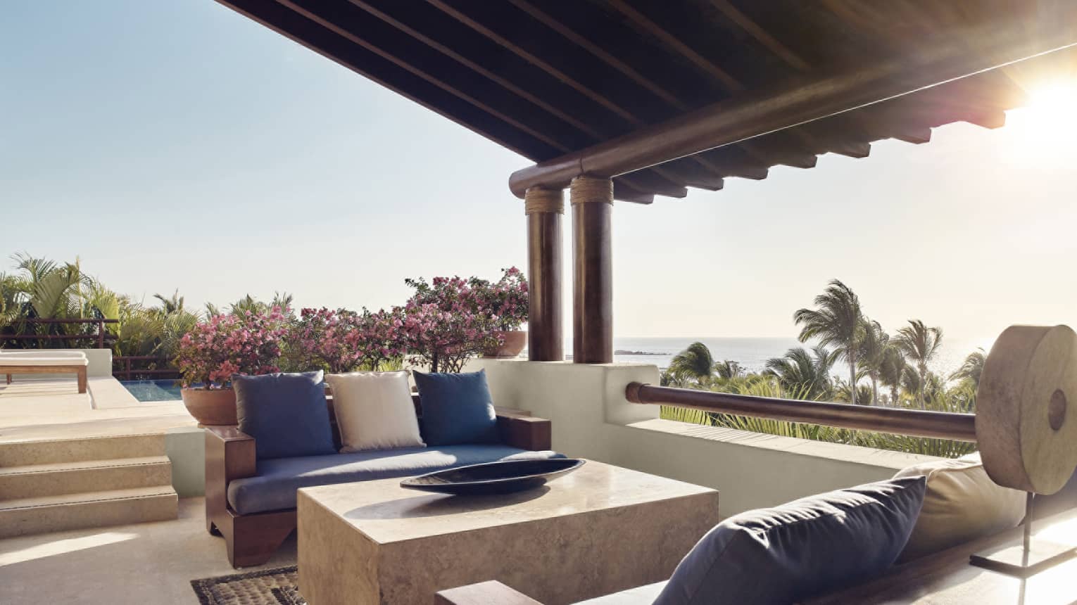 Private Pool Viila Mexico, showing covered outdoor lounge with two sofas and ocean views. 
