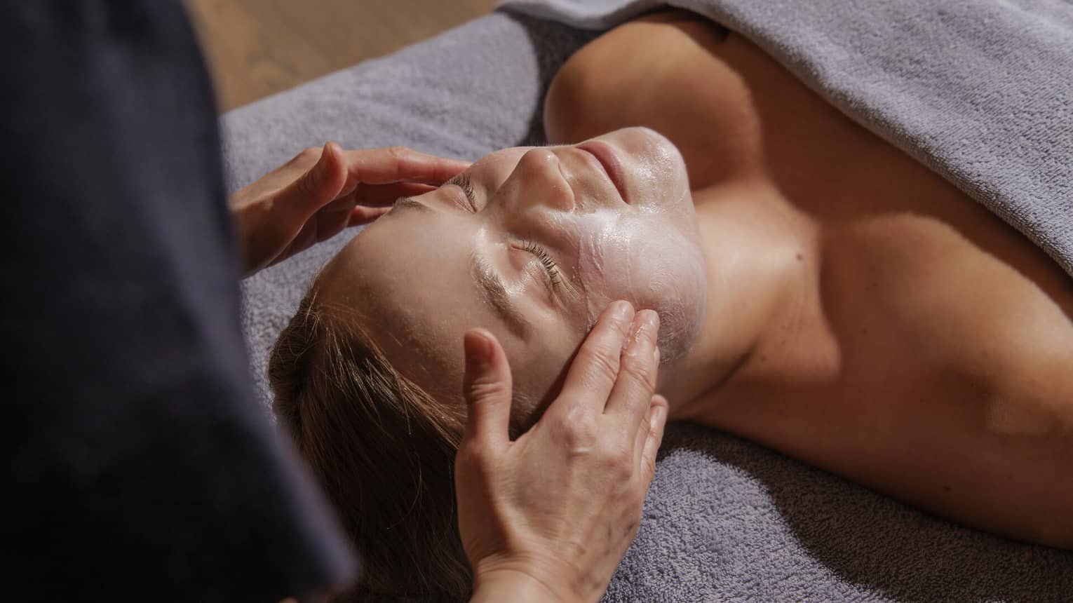 A woman getting a facial mask treatment