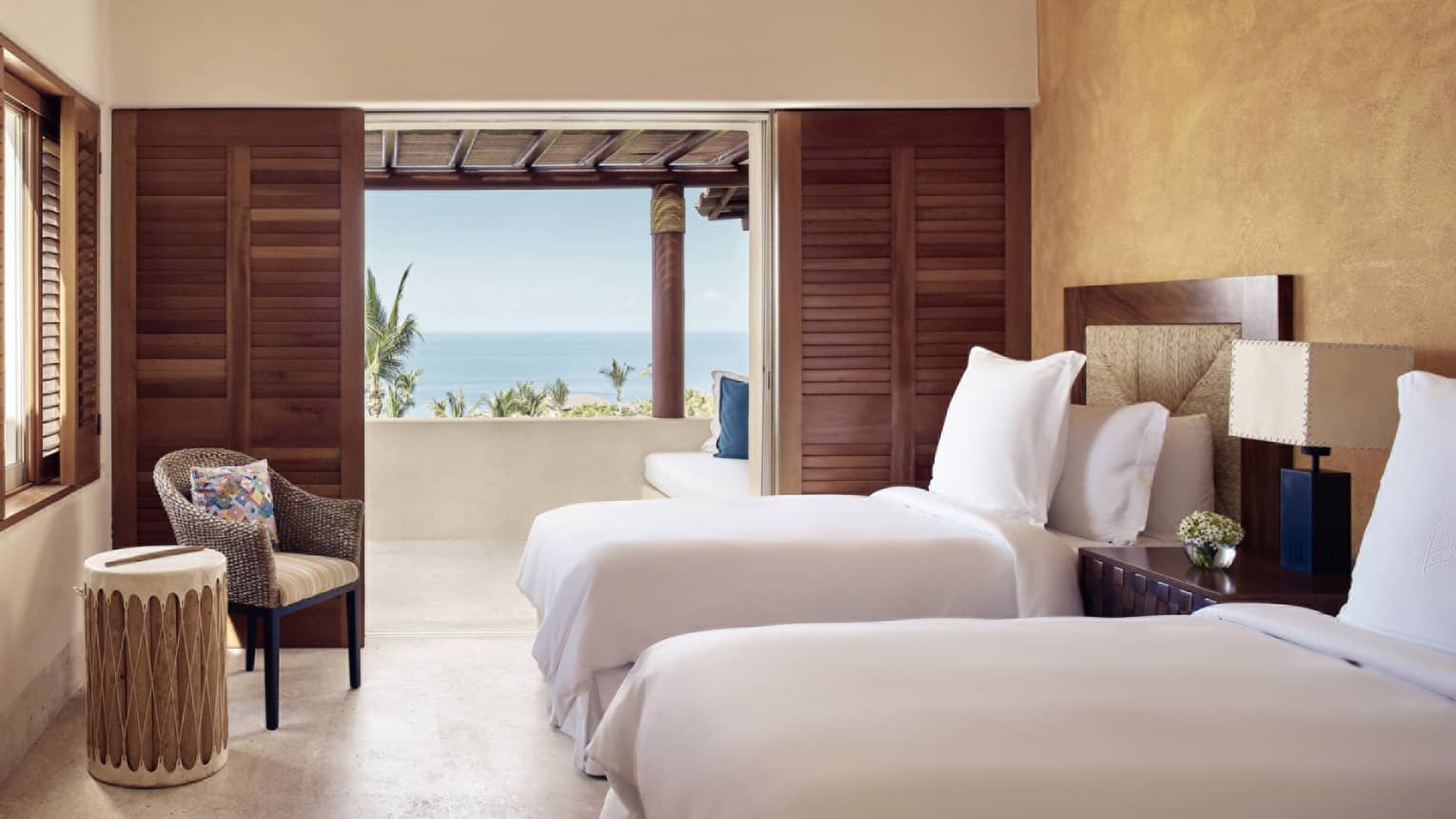 Bedroom with two twin beds, walk-out balcony with ocean view