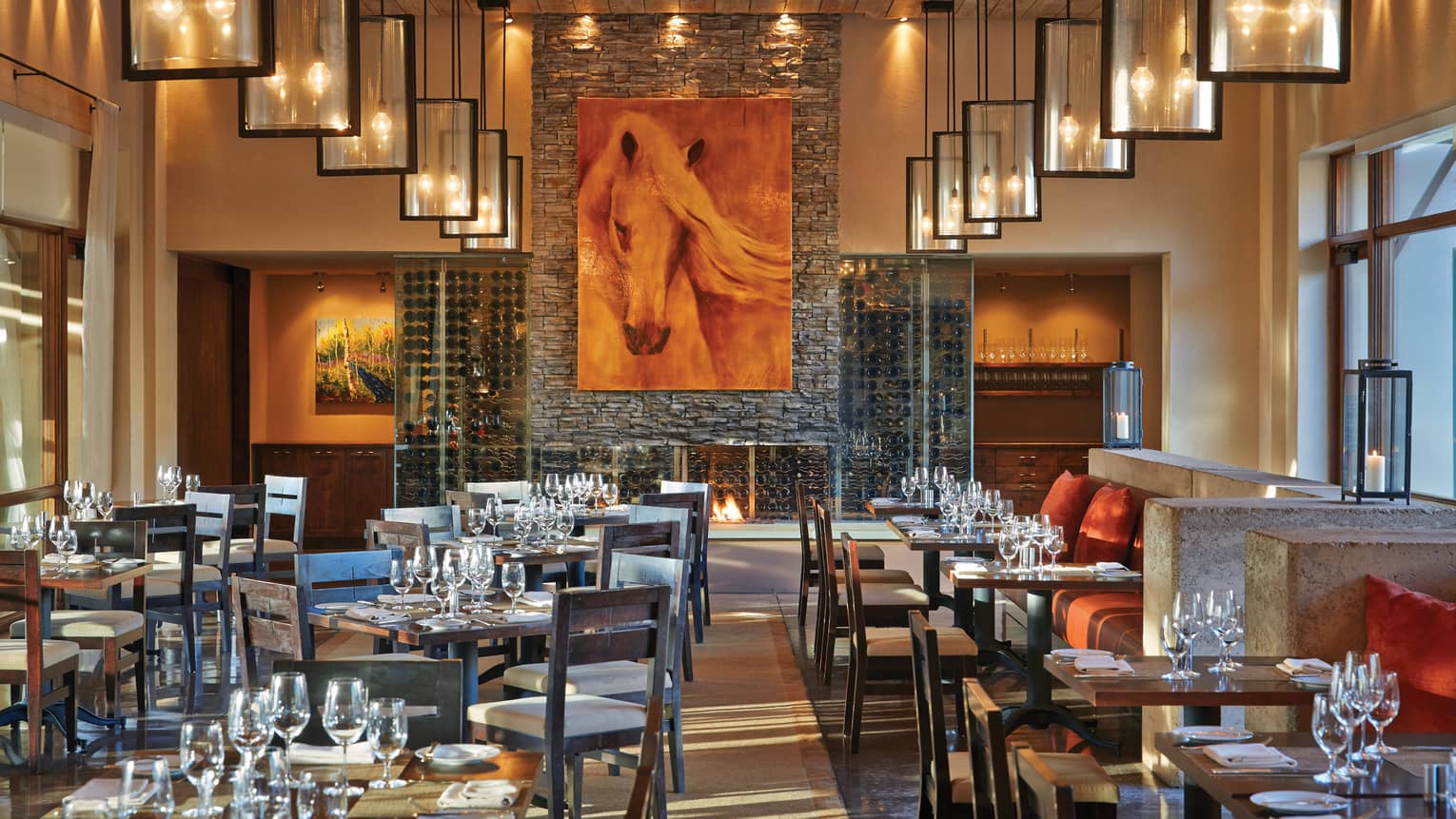 Large horse painting over stone fireplace, Terra dining tables, chairs