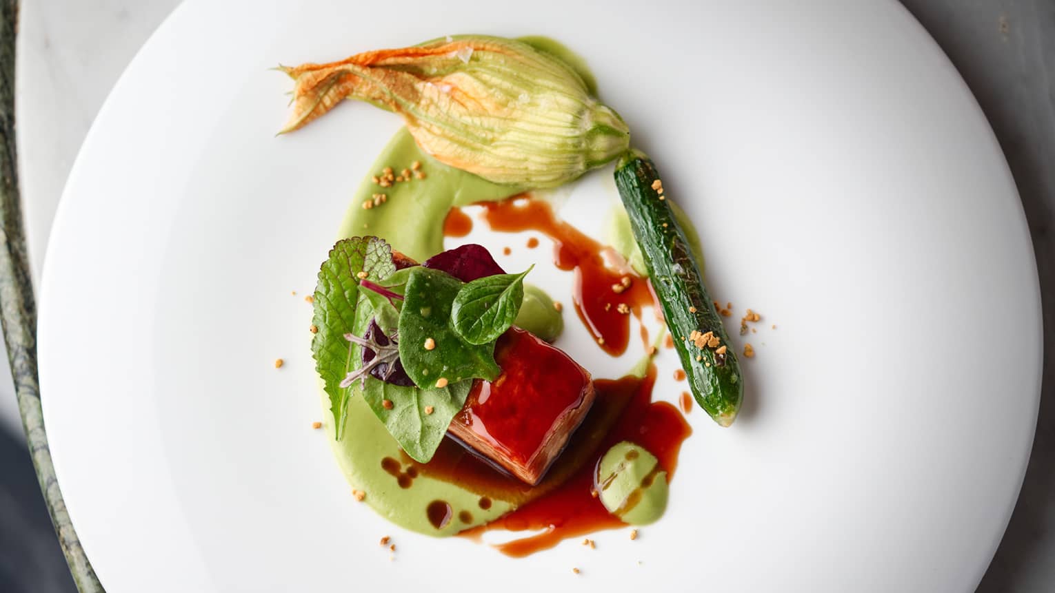 Lamb and zucchini with a red sauce.