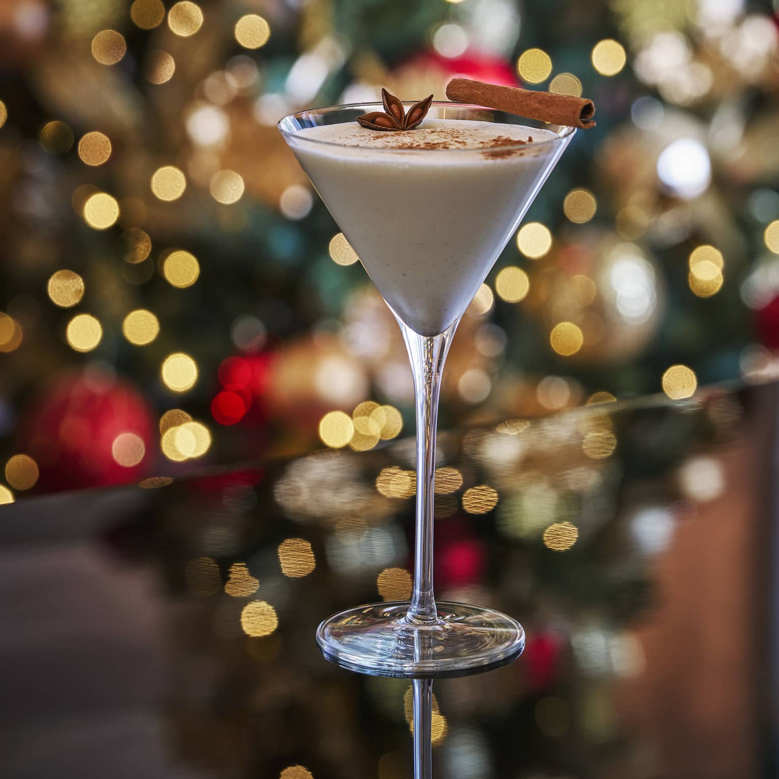 A cocktail in front of a Christmas tree.