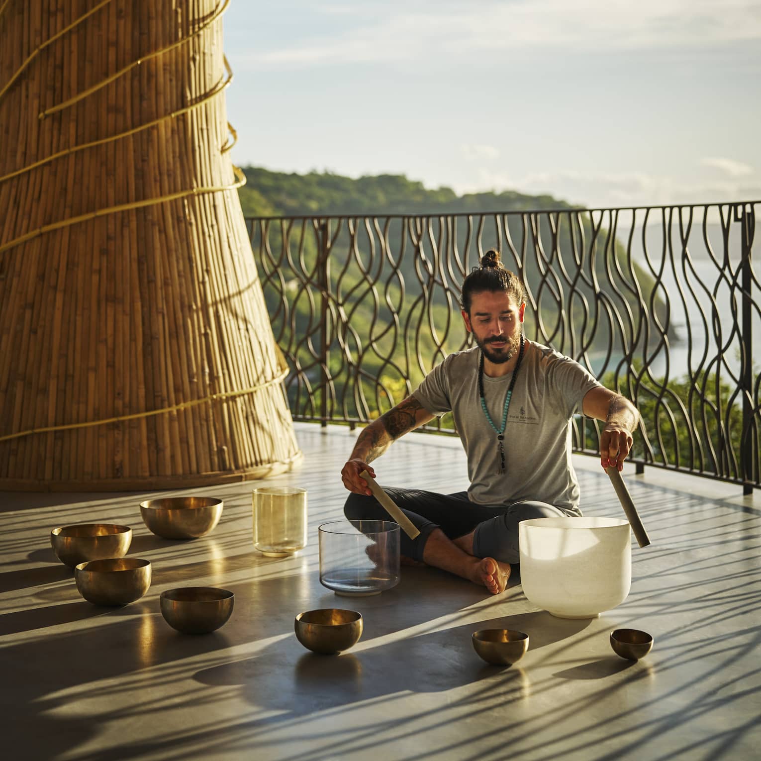 Sound healer uses crystal singing bowl in the Wellness Shala