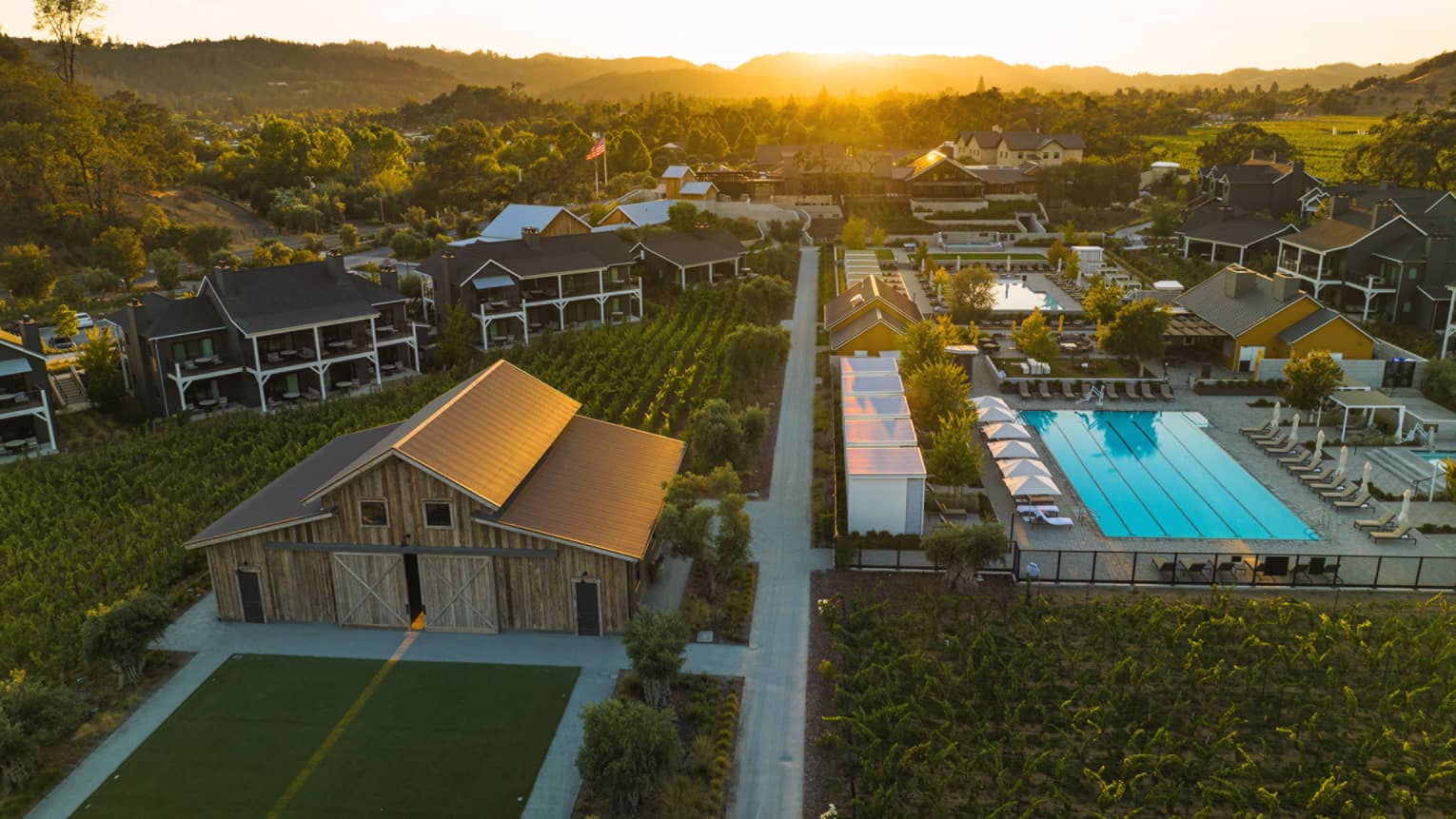 Aerial view of Four Seasons Resort Napa Valley grounds, including pool and vineyards
