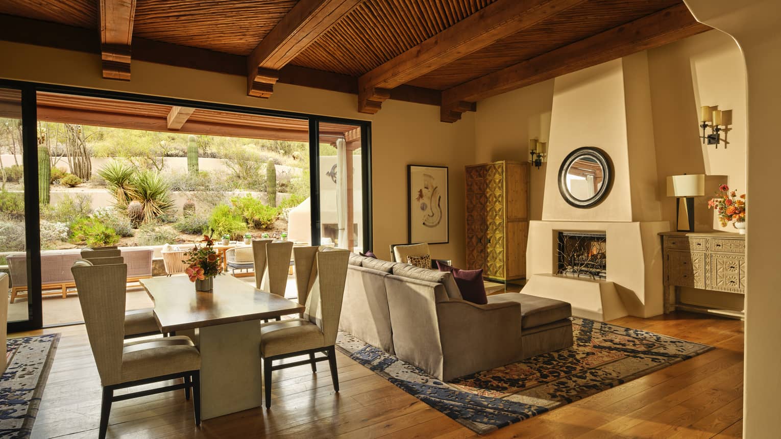 Luxury resort suite with Southwestern design, fireplace, hardwood floors, sofa and dining table