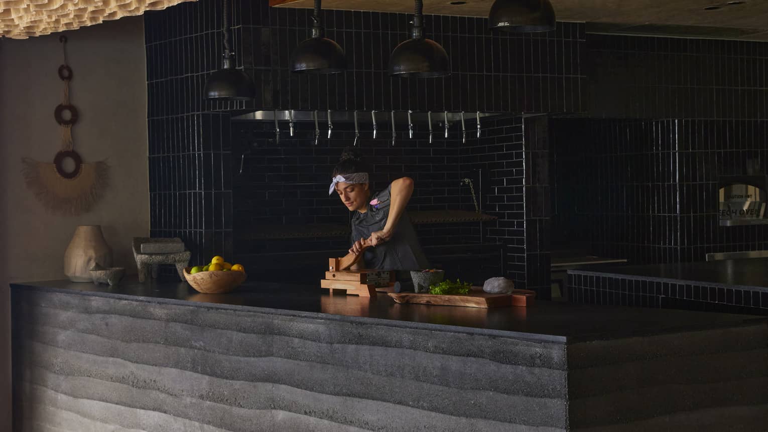 Chef Sofia works behind a counter in restaurant
