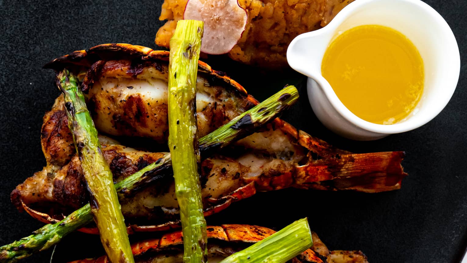 Lobster with asparagus and lemon on a plate