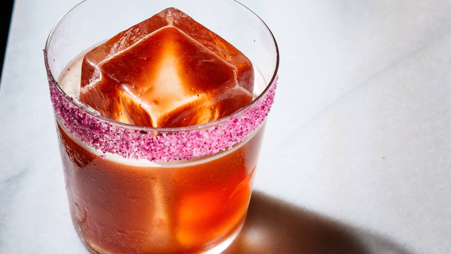 Red cocktail on a marble table
