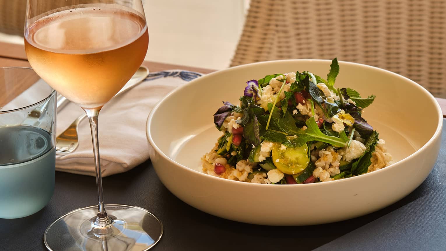 Brunch plate served on a table next to a glass of ros�