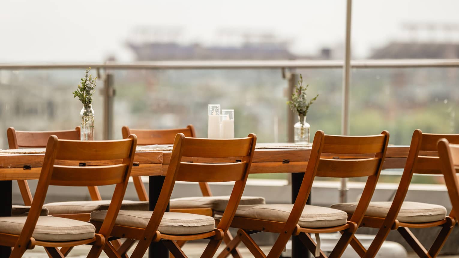 A table and chairs with umbrellas set up outside on a rooftop terrace