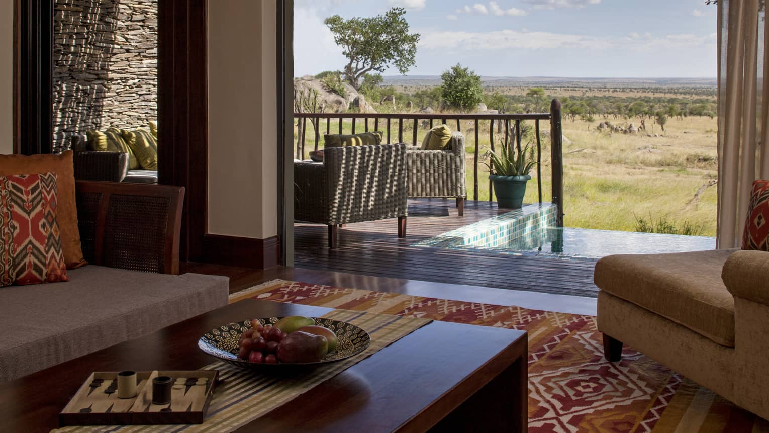 Terrace Suite coffee tables, sofas with colourful print accent pillows, open patio wall