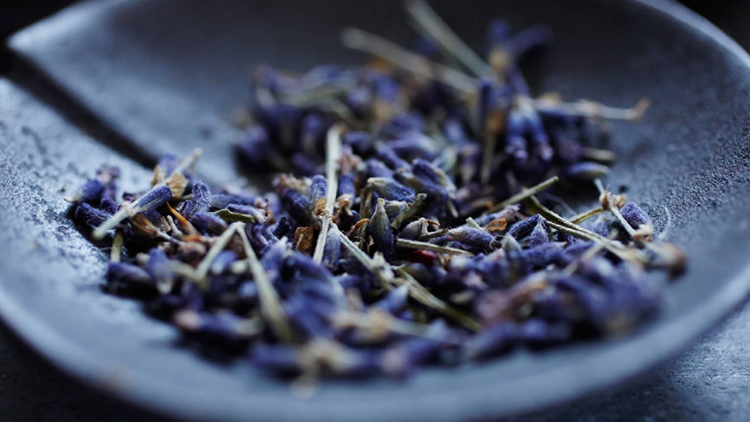 Lavender flowers in a grey bowl.