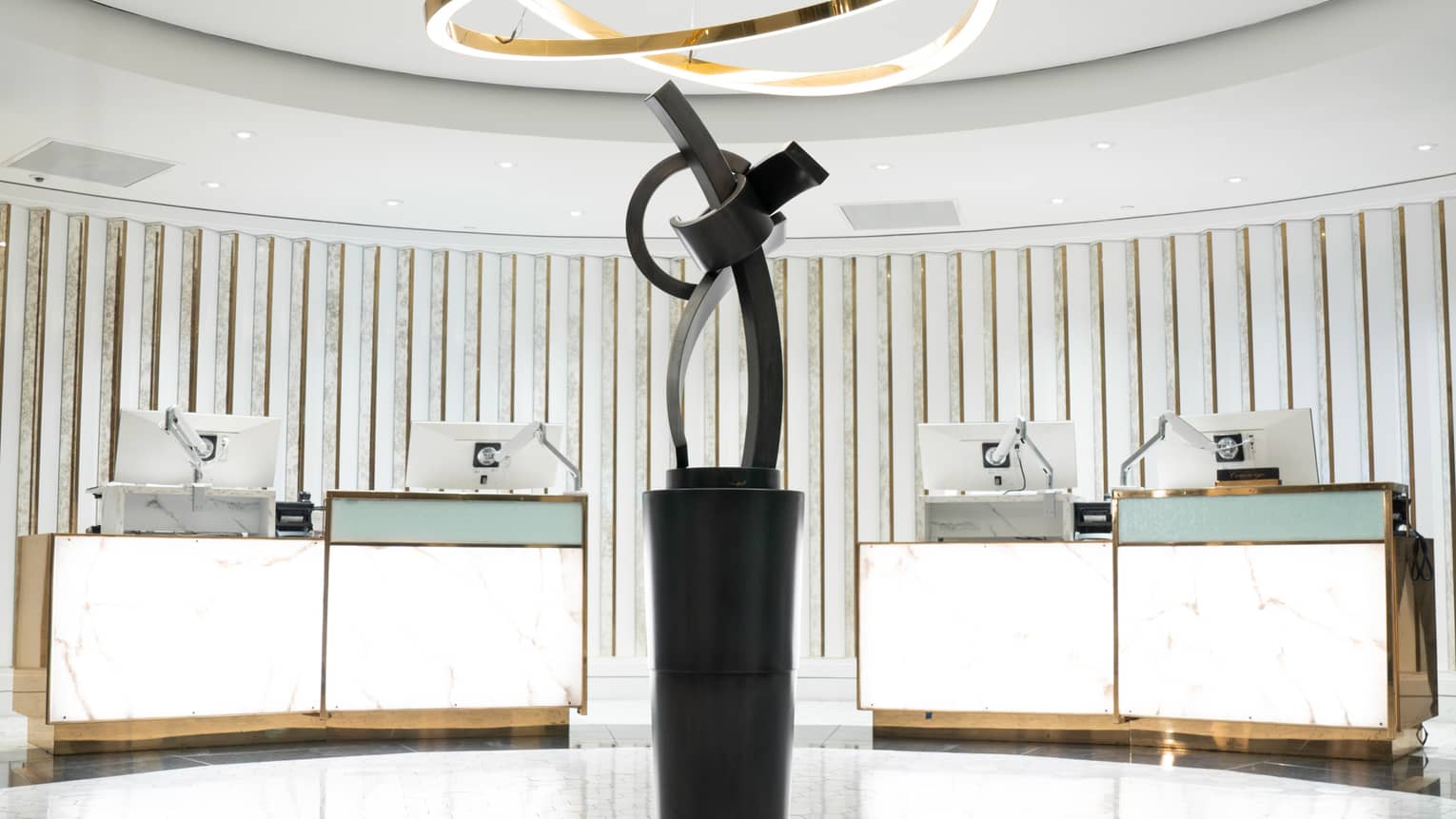 Hotel lobby with bright centrepiece light and artwork sculpture