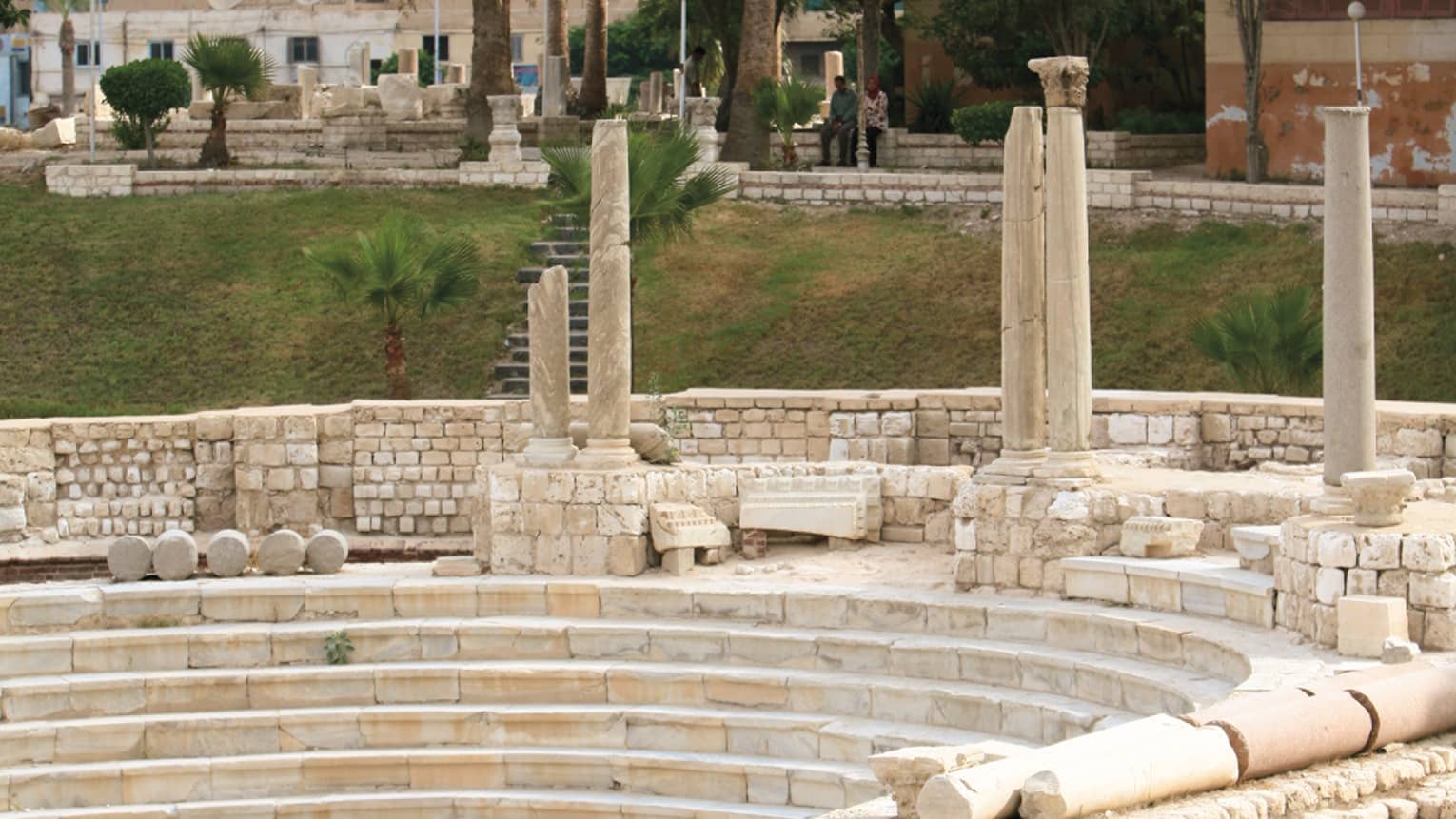 Alexandria’s Roman Amphitheatre, trees and buildings in background 