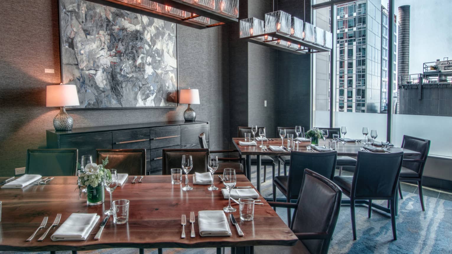Goldfinch Tavern dining room with rustic wood table, grey chairs and decor