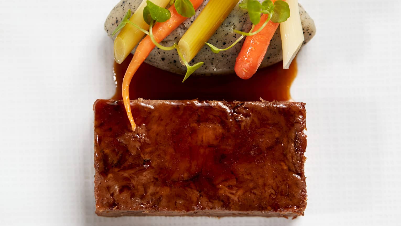 Lamb with pickles, mashed potatoes and a green sauce.