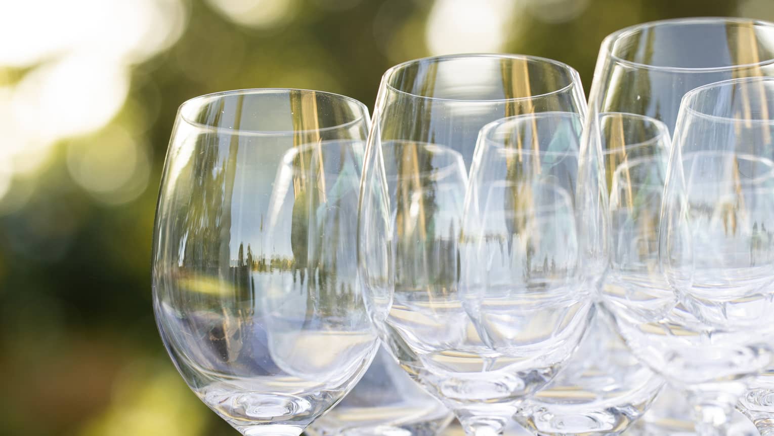 Empty wine glasses grouped together on an outdoor table