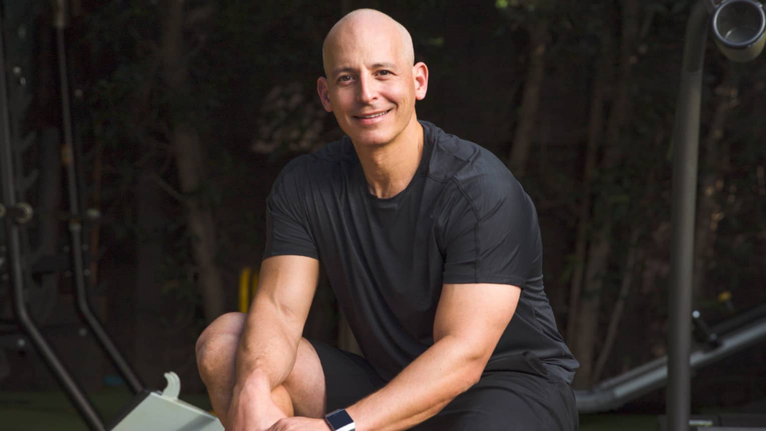 Harley Pasternak, Global Fitness Advisor, poses on a fitness machine