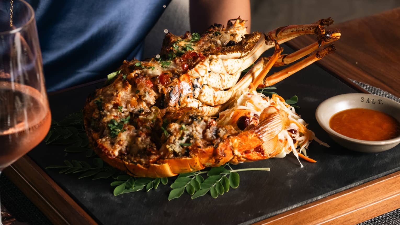 Guest putting lemon juice on their meal.