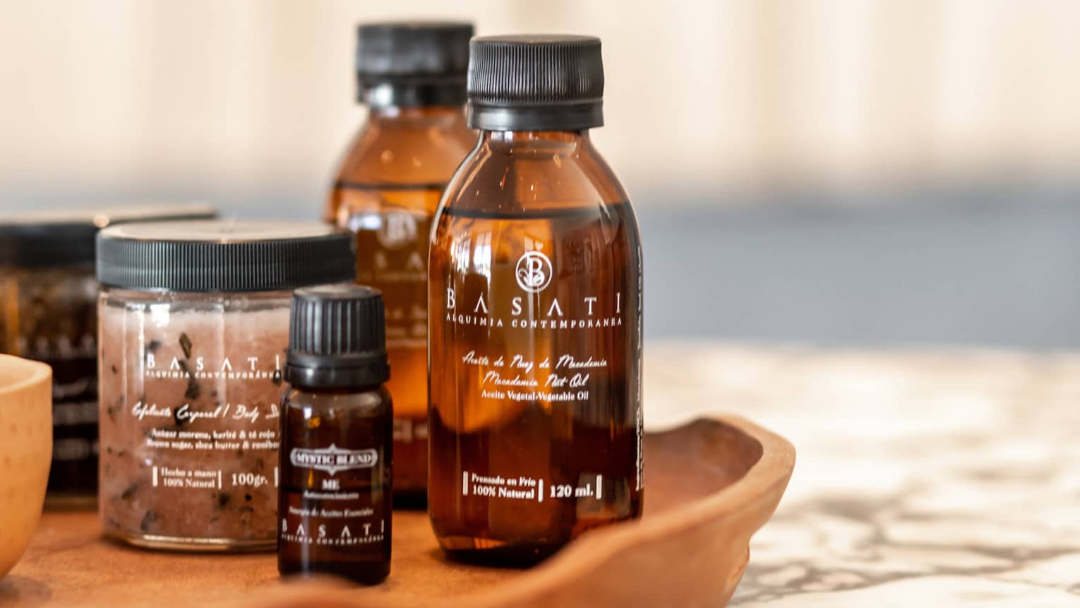 Spa ointments and other products on a wooden tray.