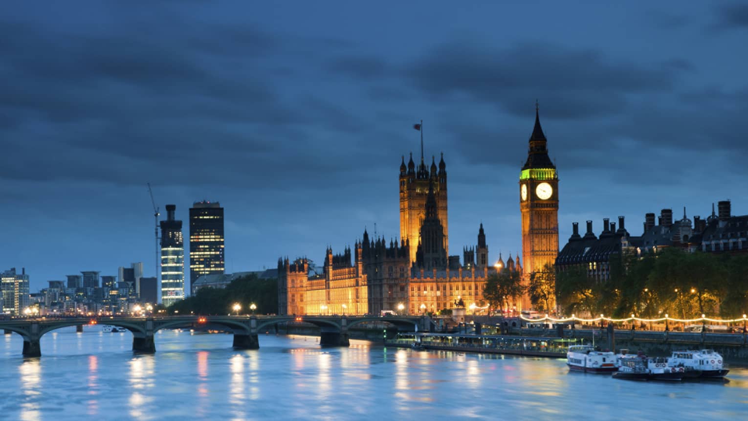 London Skyline, Big Ben tower, bridge over water at dusk