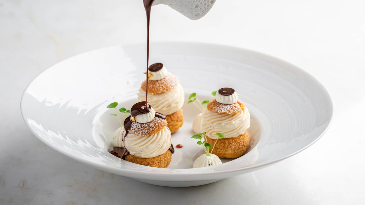 Profiteroles, vanilla ice cream and chocolate sauce