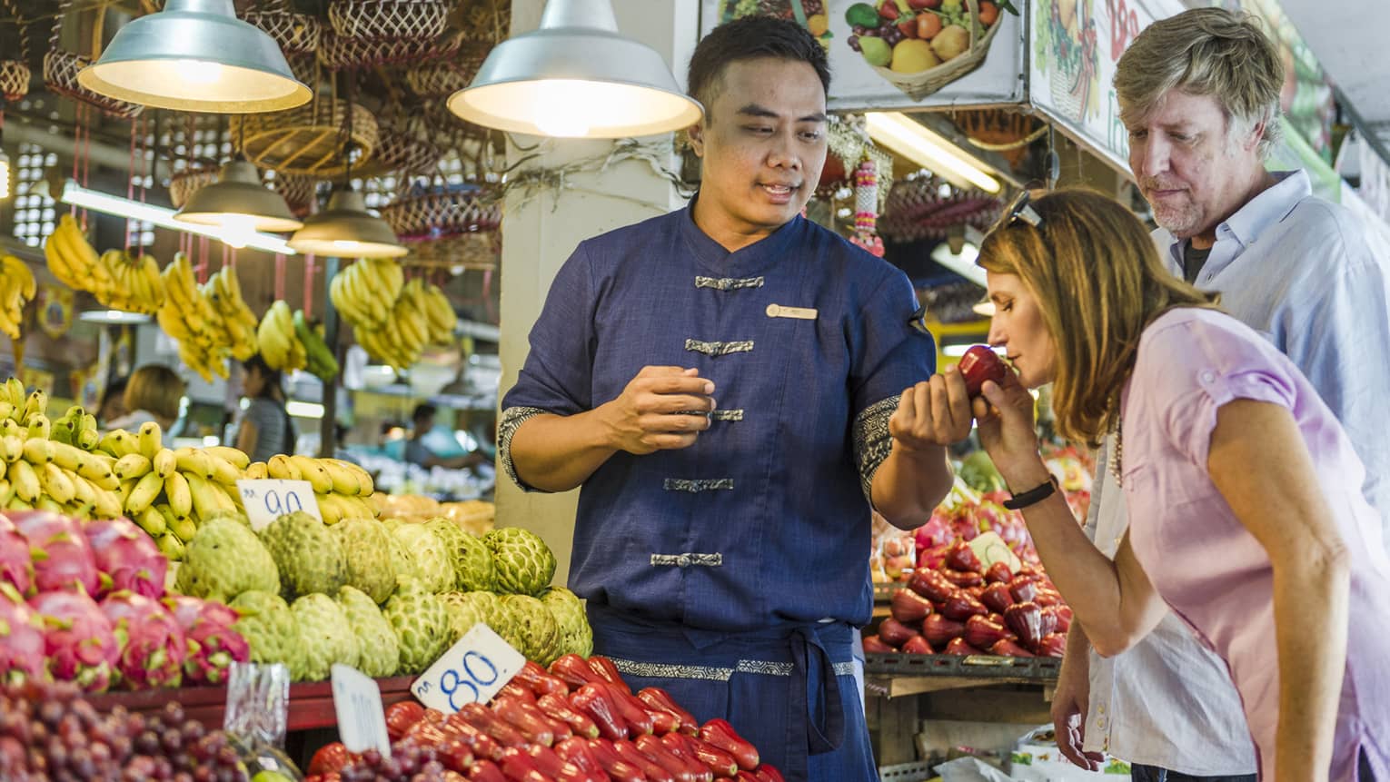 A chef showing local ingredients at a market.