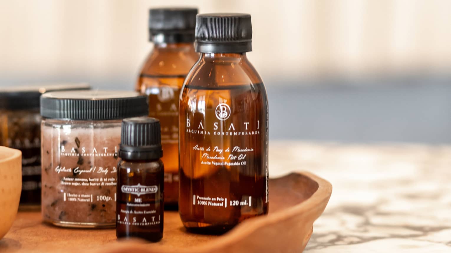 Spa ointments and other products on a wooden tray.