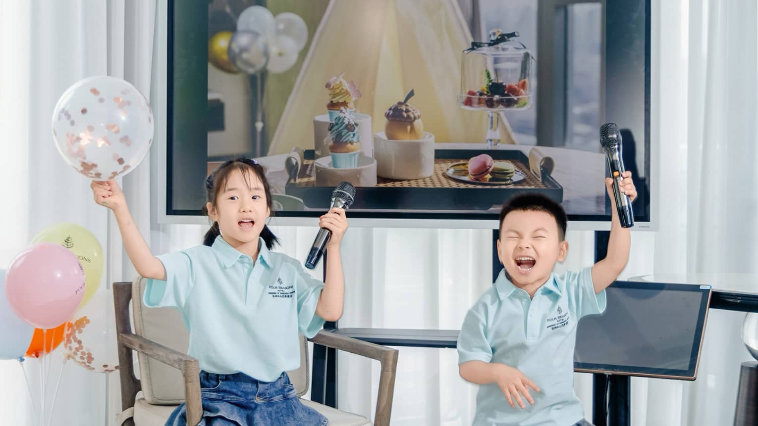 Two young children get ready for karaoke